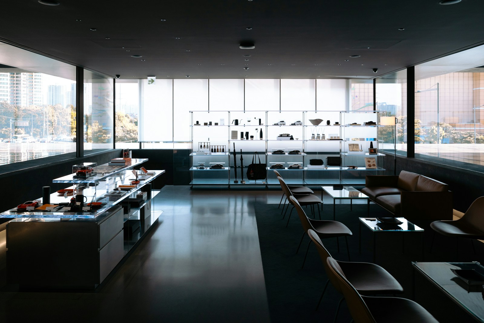 A contemporary retail interior with display cases and large windows.